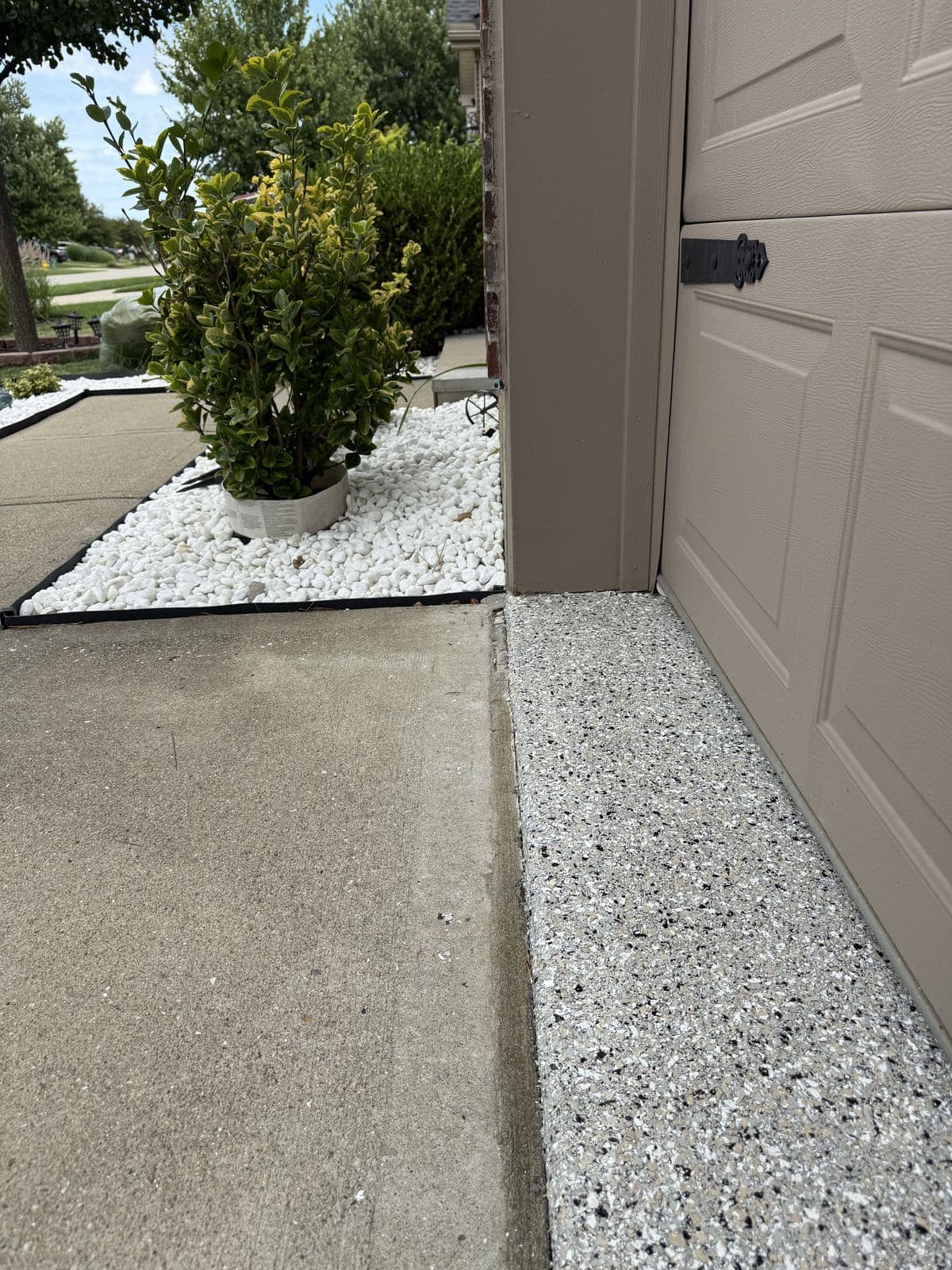 Flake epoxy coating detail at garage threshold