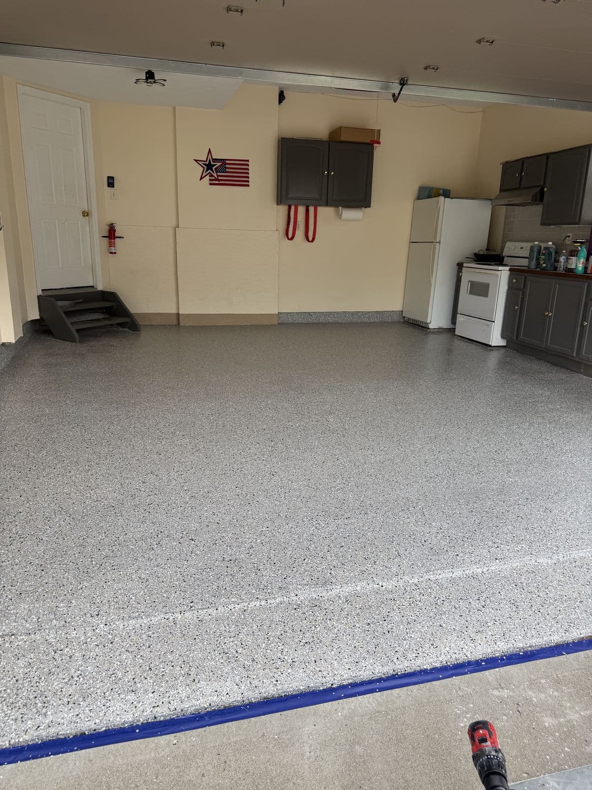 Finished garage floor with American flag and cabinets